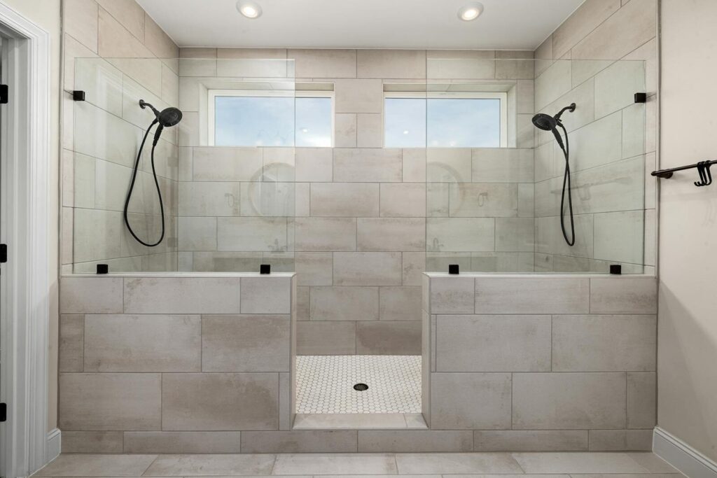 A sleek, contemporary dual shower bathroom featuring elegant tile work and modern fixtures.